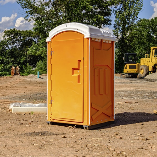 what is the cost difference between standard and deluxe portable restroom rentals in Crum